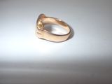 a gold ring sitting on top of a white table