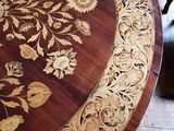 a table with a flower design on it in the middle of a room