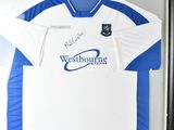 framed football shirt display in a black frame with a white and blue shirt