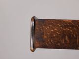 a close up of a wooden chair with a wooden seat