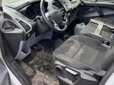 the interior of a car with the door open and the driver ' s seat down