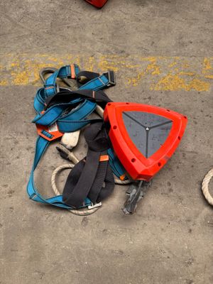 a backpack and other items on the ground next to a fire hydrant