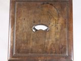 a wooden box with a metal handle on the wall
