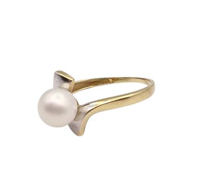 a close up of a pearl ring on a white background