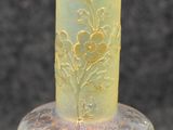 a glass vase that has a yellow and yellow design on it