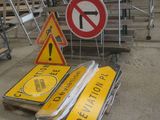 a lot of signs that are sitting on the ground