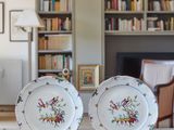 deux assiettes posées sur une table devant une bibliothèque