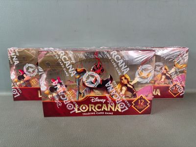 two disney figurines are sitting in a box on a table