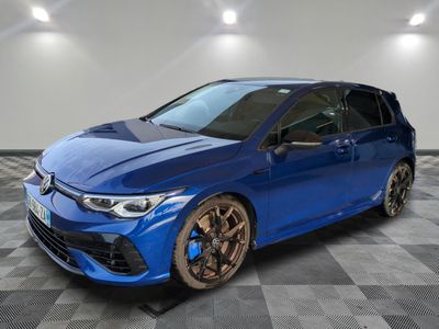 a blue toyota coroll is parked in a room with checkered floor