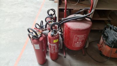several fire extinguisors are lined up next to each other