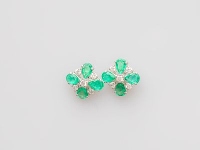 a pair of emerald and diamond earrings