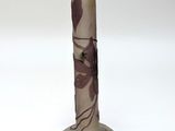 a vase with a flower design on it on a white surface