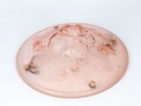 a pink plate with some food on it on a white surface