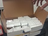 a person reaching for a box full of white boxes