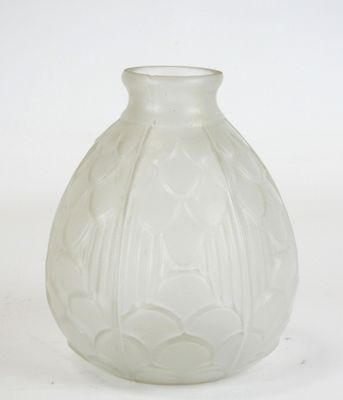 a white glass vase with a design on it
