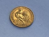 an old gold coin sitting on top of a blue surface