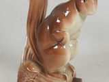 two figurines of a squirrel sitting on top of each other