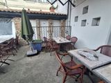 many tables and chairs on the patio outside of a building