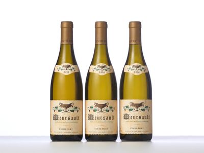 three bottles of wine sitting on top of a white table