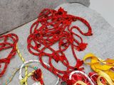 a pile of different colored cords on a couch