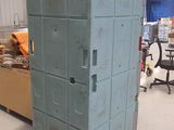 a large stack of metal boxes in a warehouse