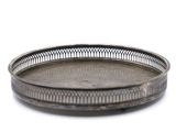silver plate on a white background with a pattern on the rim
