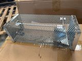 a close up of a metal animal trap on a cardboard box