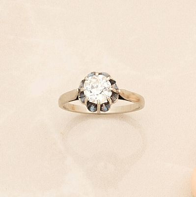 a diamond ring sitting on top of a table