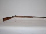 a rifle on a table with a white background