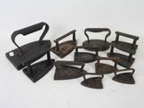 a lot of old irons that are sitting on a table
