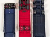 three toy trains sitting next to each other on a white surface
