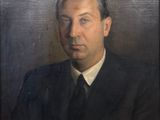 portrait of a man in a suit and tie in front of a black background