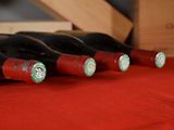 several bottles of wine are lined up on a red table