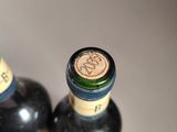 two bottles of wine sitting next to each other on a table