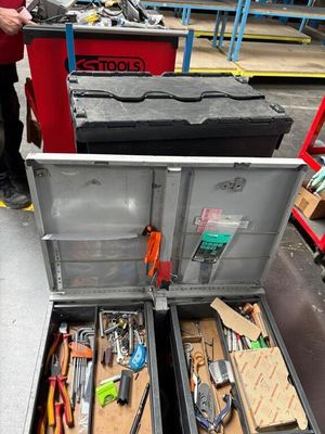 de nombreux outils dans une boîte à outils posée par terre