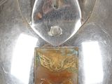 a silver helmet with a gold emblem on it