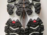 the soles of a pair of running shoes on a white surface
