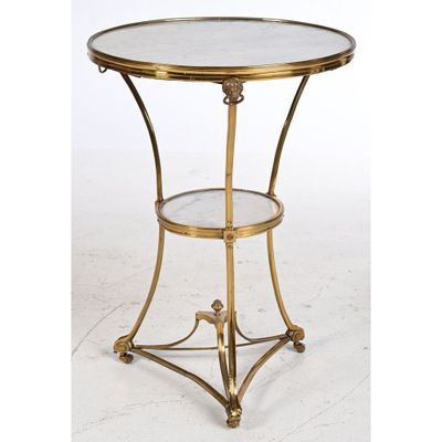 a gold metal table with a glass top on a white background