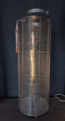 a metal container with a light inside of it on a table