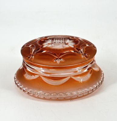 an image of a glass container with a lid sitting on a white surface
