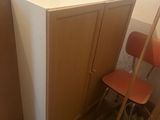 two chairs and a desk in a room that is under construction