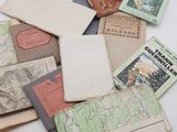 a pile of old maps and books on a table