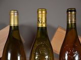 three bottles of wine sitting on a table next to each other