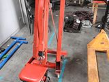 a red lift truck that is parked in a garage