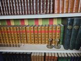 many books that are on a shelf in a library