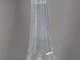 a clear glass bottle with a handle on a table