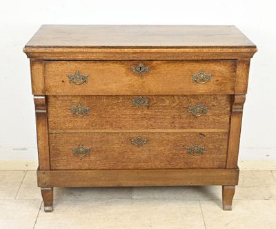 an old wooden chest of drawers sitting on top of a tiled floor