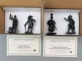 three black figurines of soldiers in a cardboard box on a table