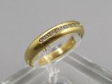a close up of a gold ring with diamonds on it