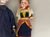 two dolls that are laying on the floor next to each other
